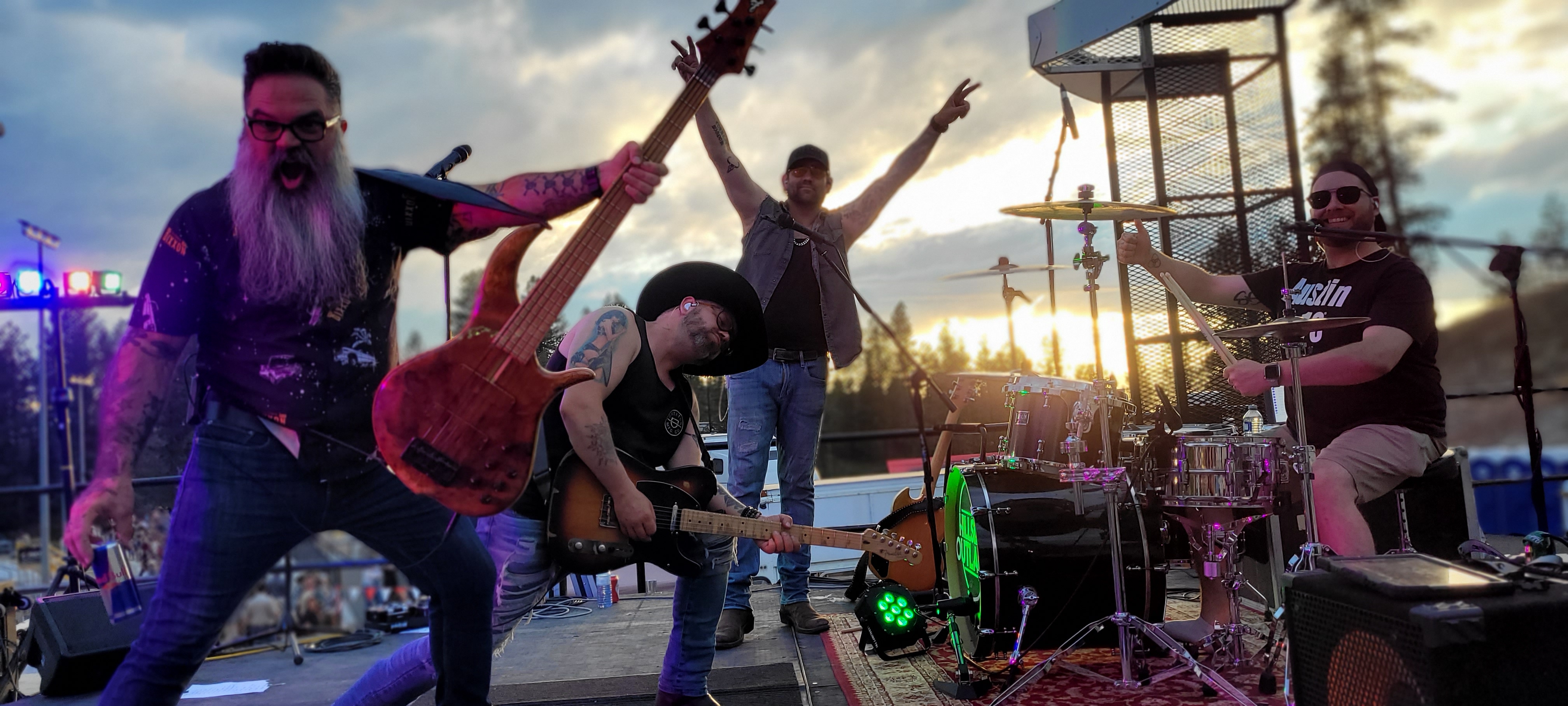 Rock band performing live at sunset outdoor stage managed by Audio Junkie Music