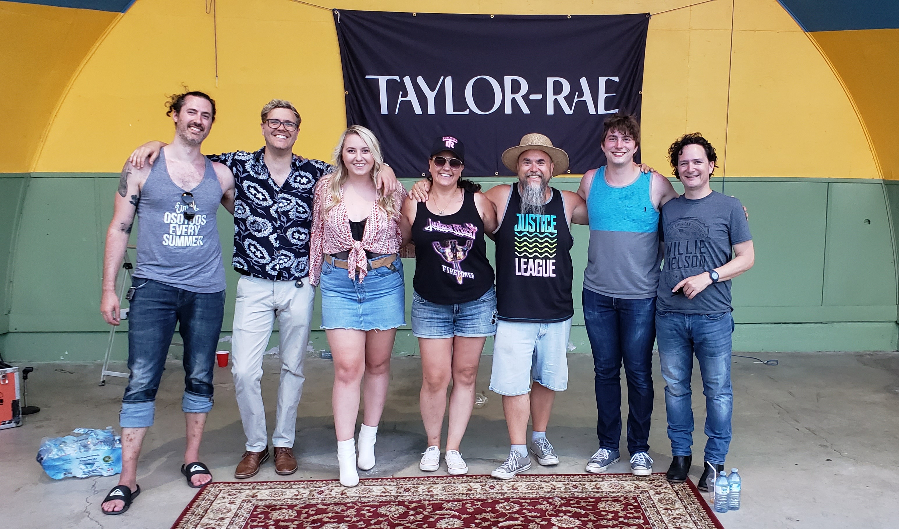 Group photo with Taylor Rae and band on an outdoor community stage floor mat